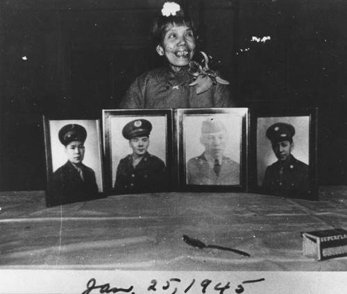 Woman with portraits of sons
