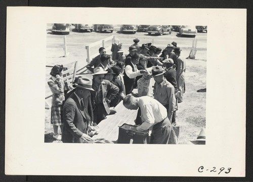 Turlock, Calif.--Baggage is inspected as families arrive at Turlock Assembly center. Evacuees of Japanese ancestry will be transferred later to War Relocation Authority centers where they will spend the duration. Photographer: Lange, Dorothea Turlock, California