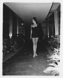 Black one-piece, strapless bathing suit modeled at the Sword of Hope fashion show at the Flamingo Hotel, Santa Rosa, California, June 18, 1960