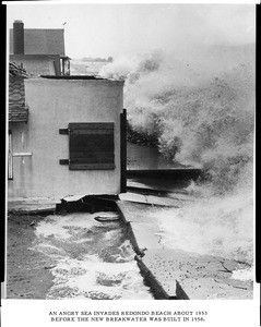 Waves crashing against the edge of a house in Redondo Beach during a storm, ca.1953