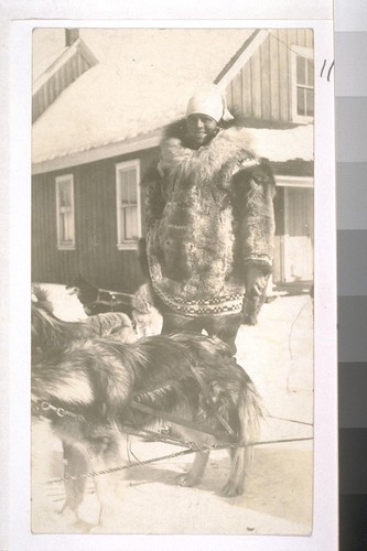 [Jack London with dog in snow.]
