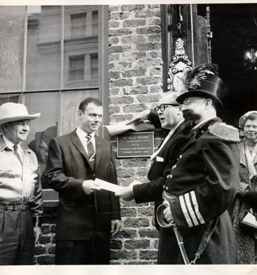 [Donald A. Wells, Melvin M. Belli and Emperor Norton standing in front of the Belli Building]