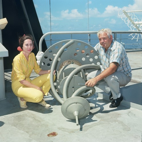 Unidentified man and geologist Betty Gealy aboard the research ship D/V Glomar Challenger during the Deep Sea Drilling Project. Circa 1968