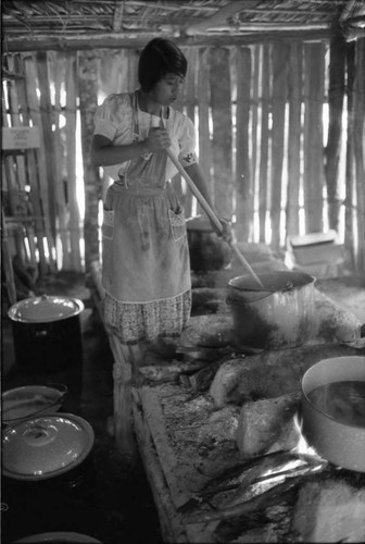Refugee woman and cooking utensils, Chiapas, 1983