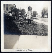 Muriel Salas posing with toy in front yard