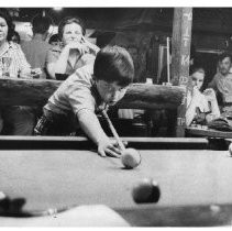 Louis Griffin, young pool player, lines up a shot