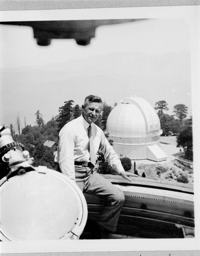 William Meggers at Mount Wilson Observatory, sitting in the dome of the 150-foot tower telescope, with the 100-inch telescope in the background