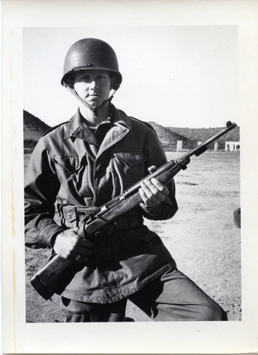 Trainee posing with M1 Carbine rifle at Fort Ord