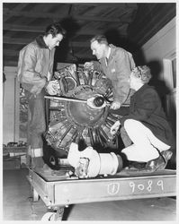 Unidentified airplane mechanics working on a Pratt & Whitney airplane engine, 1960s