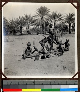 Boys cleaning a bicycle at Shendam Mission, Nigeria, 1923