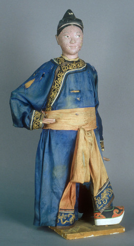 Puppet, male standing figure, one hand on hip. Blue gown, black & gold