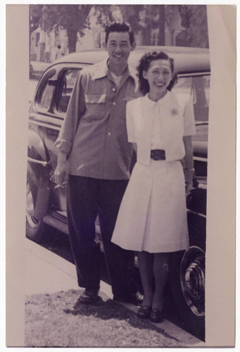 Minoru Frank Saito and Nisei woman standing next to car