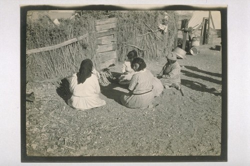 The Shoshone Indian Squaws playing a game by the Wickiup