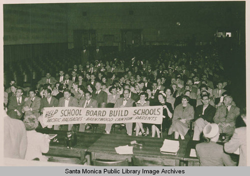 Crowd with banner assembled to demonstrate for the building of the Paul Jr. High Revere School, Los Angeles, Calif
