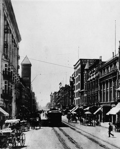 Broadway looking south from First Street with office buildings, horse and buggy, and trolley cars