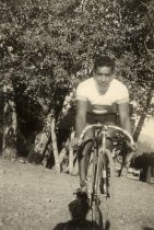 Bike racer posing on bike in front of trees