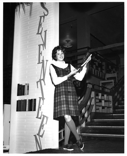 Female Sales Clerk Modeling P.F. Canvas Sneakers Inside Hart's Department Store