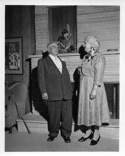 Mr. and Mrs. Devincenzi Posing in Front of the Fireplace