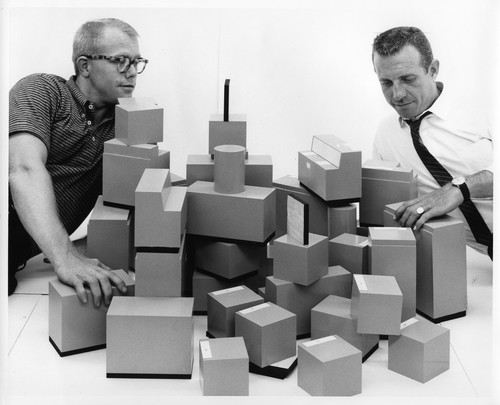 Two Men Arranging Model Building Blocks Representing IBM Data Processing Systems