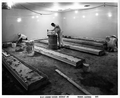 Workers Cementing Floor Areas Inside a Fremont GMC Assembly Plant Building