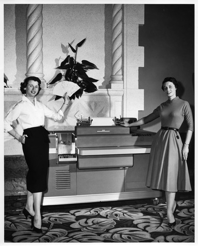 Two Women Showcasing the IBM RAMAC Accounting Computer System