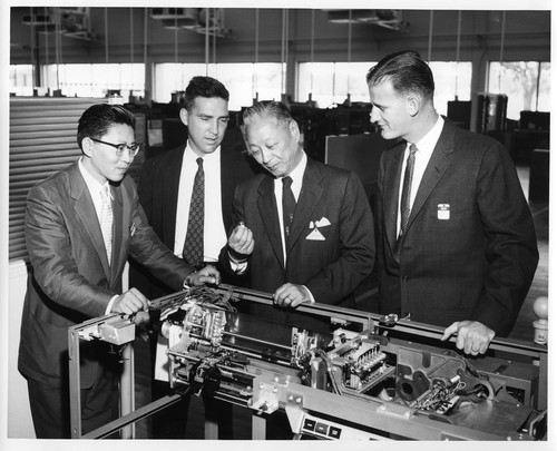 Businessmen Inspecting the Interior Mechanisms of an IBM Data Processing System