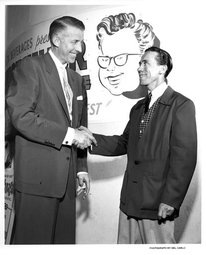 Two Unidentified Males Shaking Hands During a KLOK Live Radio Show