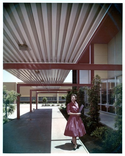 Woman Standing Outdoors Under an IBM San Jose Building 25 Covered Walkway