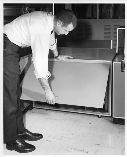 Unidentified Male Closing the Removable Lid of an IBM Data Processing Unit