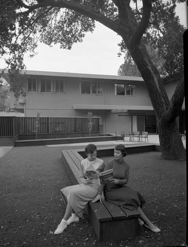 Two SJSC Kappa Alpha Theta Members Sitting Outside Their Sorority House