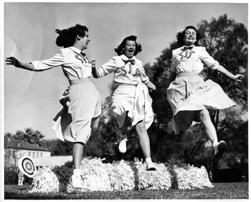 Action Shot of Three Female San Jose State College Cheerleaders