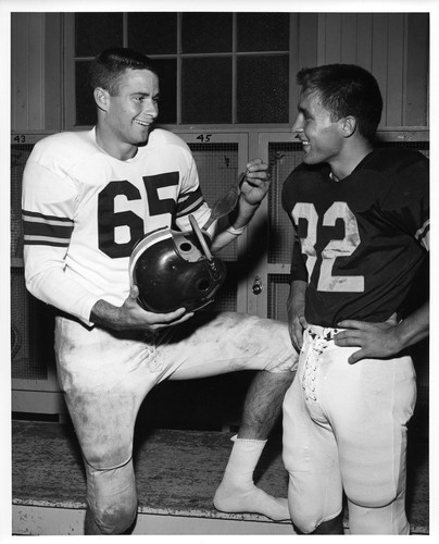 Two San Jose State College Football Players Conversing in the Locker Room