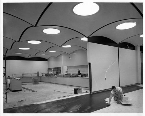 Worker Placing Linoleum Tiles Inside the Future Fremont GMC Plant Cafeteria