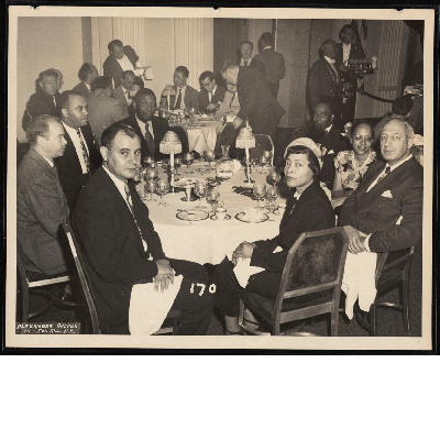 Unidentified men and women at dinner banquet