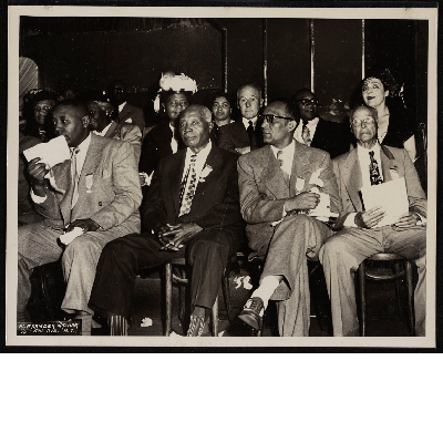 Platform guests sitting at convention session