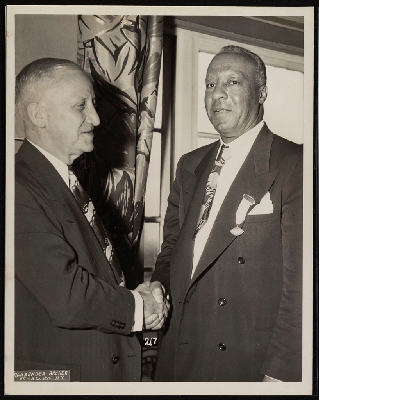 A. Philip Randolph shaking hands with William J. Kennedy