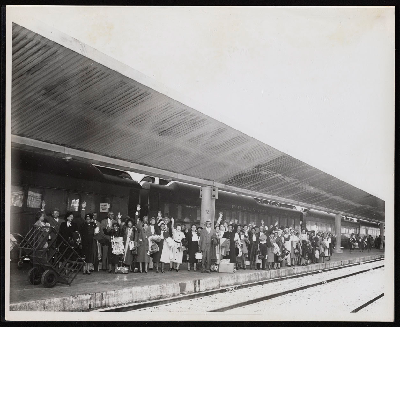 Attendees of the convention of the Brotherhood of Sleeping Car Porters with suitcases on train platform in front of Pullman train car