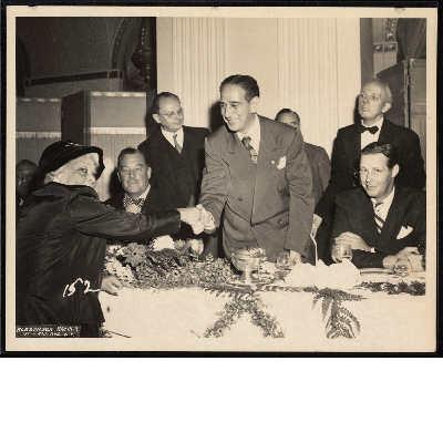 Lucille Campbell Green shaking hands with Vincent Impellitteri, Maurice Tobin sitting to the right