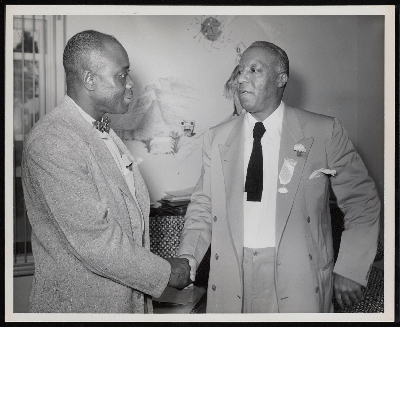 A. Philip Randolph shaking hands with unidentified man