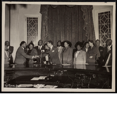 Group photograph (left-right): Mrs. E.J. Bradley, Thomas T. Patterson, A. Ralph Bunche, Mrs. M.P. Webster, A. Philip Randolph, Lucille Campbell Green, Vincent Impellitteri, B.F. McLaurin, Mrs. McLaurin, Mrs. Ashley Totten, Mrs. B. Smith, Mrs. T.D. McNeal, Grover Whalen, J.C. Mills