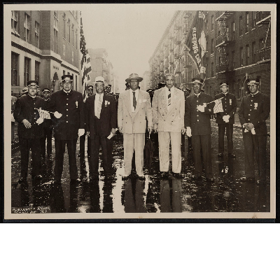 Group photograph in rainy street (left-right): M.M. Coleman, W.C. Mills, Ashley L. Totten, A. Philip Randolph, William H. Bowe, D. LaRoche, J.L. Reynolds, H.A. Rock