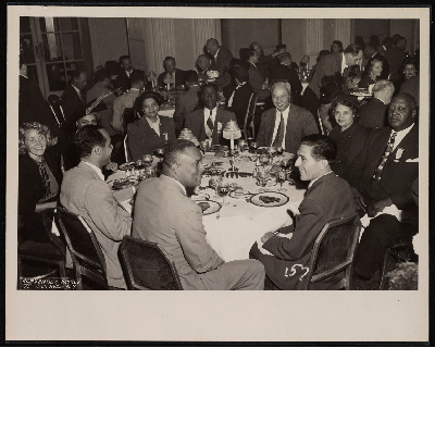 Dinner banquet (left-right): Comm. Ray Jones, unidentified, unidentified, Mrs. Helena Wilson, Mrs. Bennie Smith, Bennie Smith, Judge Rivers, Mrs. W.P. Webster, W.P. Webster