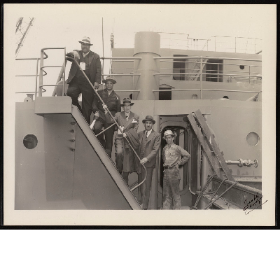 C.L. Dellums (second from right) standing on deck steps with four men