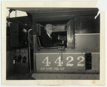 Train engineer seated at controls of locomotive no. 4422