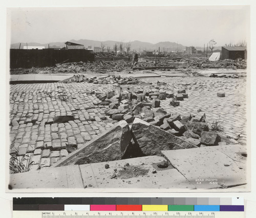 [Subsidence and fissures along street. Unidentified location. (South of Market St.?) Twin Peaks in distance, left center.]