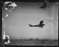 Biplane flying near Griffith Park Airport, Los Angeles, [1928?]