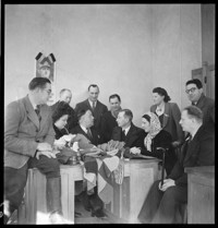 Reims: [Pierre Schneiter with men and women in an office]