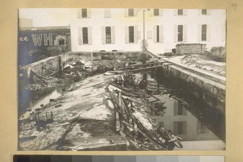 No. 1 Fremont Street, east side, beginning 137 ft. south of Market; walls settled and basement floor forced up during earthquake. As here shown, walls have been removed above concrete work, leaving earthquake effects exposed. We are driving piles in lot next, northward, and find they drive very easily to depth of 38 to 42 ft. +-, thus showing the softness of foundation. W. L. Huber, Jan. 23, 1908