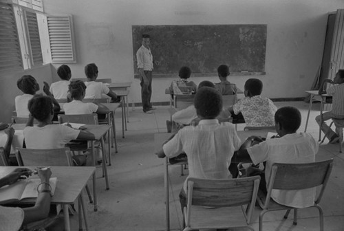 Teenagers and children in a classroom with teacher, San Basilio de Palenque, 1976