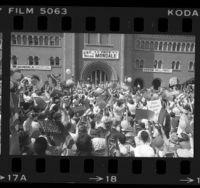 Crowd waving Mondale/Ferraro placards at Walter Mondale during campaign stop at USC, 1984